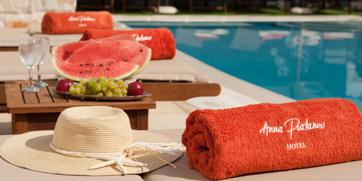 Enjoy a refreshing cold beverage by the pool in Anna Platanou Hotel