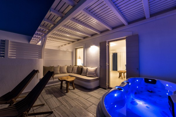 Balcony with outdoor jacuzzi at night