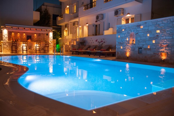 The central pool at Anna Platanou Hotel by night